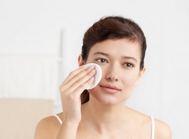 Bioderma - woman cleansing her face